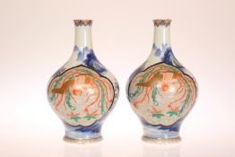 A PAIR OF JAPANESE IMARI VASES, each decorated with a three-claw dragon,