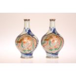 A PAIR OF JAPANESE IMARI VASES, each decorated with a three-claw dragon,