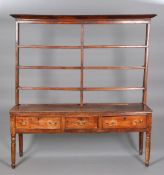 AN EARLY 19TH CENTURY OAK AND ELM DRESSER AND RACK, the open rack with projecting cornice,
