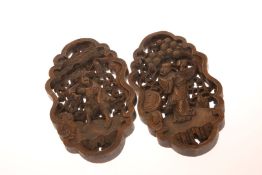 A PAIR OF CHINESE WOODEN WALL CARVINGS, with figures in a foliate background. 28.