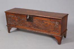 AN OAK AND ELM SIX PLANK CHEST, with moulded top and carved front, raised on bracket feet. 48.
