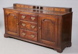 A GEORGE III OAK DRESSER BASE, the moulded rectangular top with spice drawers,