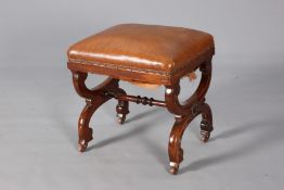 A REGENCY STYLE UPHOLSTERED AND MAHOGANY STOOL, of X-form, moving on castors. 47.5cm.