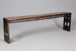 A CHINESE HARDWOOD LONG BENCH OR TABLE, 19TH CENTURY, with carved and pierced trestle ends,