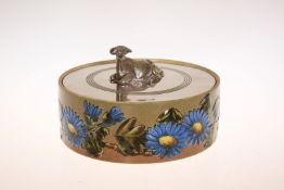 A LINTHORPE POTTERY BUTTER DISH, circular, enamel painted to the sides with flowers and foliage,
