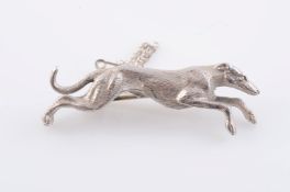 A SILVER BROOCH, modelled as a racing greyhound. Stamped SILVER. Length 5cm. Weight 15.5 grams.
