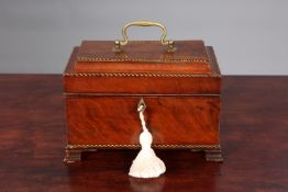 A GEORGE III MAHOGANY TEA CADDY, with chequered inlay, brass handle and bracket feet.