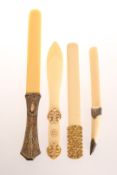 A LATE 19TH CENTURY SILVER-MOUNTED IVORY PAGE TURNER AND THREE IVORY LETTER OPENERS,