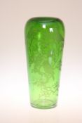 AN ETCHED GREEN GLASS VASE, c. 1900, of tapering form, decorated with birds perched on leafy boughs.