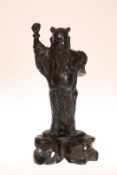 A CHINESE BRONZE FIGURE OF A SAGE, 19th Century, cast standing on a naturalistic base.