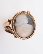AN 18TH CENTURY ECCLESIASTICAL RING, the oval mount with carved cameo profile of a gentleman,