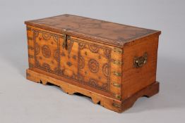 A 19TH CENTURY BRASS STUDDED TEAK TRUNK, the studs arranged in a geometric formation,
