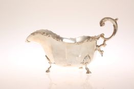 A GEORGE V SILVER SAUCEBOAT, LONDON 1930, in 18th century style with faceted body,