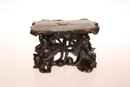 A 19th CENTURY CHINESE CARVED HARDWOOD STAND, the top of rectangular form, modelled as a lotus leaf,