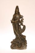 A CHINESE BRONZE FIGURE GROUP OF QUAN YIN, cast with child and wearing flowing robes.