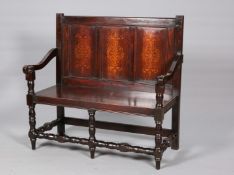 AN OAK SETTLE IN 17TH CENTURY STYLE, with three-panel back and block and baluster legs. 112cm wide.