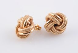 A PAIR OF YELLOW GOLD KNOT STYLE EARRINGS, of polished and textured metal details,