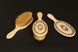 A CHINESE EXPORT IVORY DRESSING TABLE SET, comprising a pair of brushes and a hand mirror,