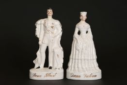A PAIR OF VICTORIAN STAFFORDSHIRE FIGURES OF QUEEN VICTORIA AND PRINCE ALBERT, on gilt titled bases.
