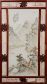 A CHINESE PORCELAIN PLAQUE, painted with a mountainous river landscape, in a wooden frame.