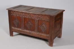 A 17TH CENTURY OAK COFFER, the moulded three-panel lid carved with the initials ID,