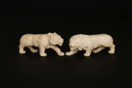 TWO CARVED IVORY MODELS OF LIONS, late 19th Century. Each circa 10.