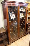 Good mahogany astragal glazed two door cabinet having four adjustable plate glass shelves,