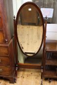 Oval mahogany cheval mirror on four downswept legs