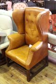 Georgian style tan buttoned back leather wing armchair