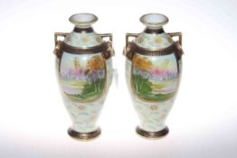 Pair Noritake two handle vases, each painted with landscape panel,