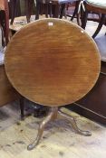 19th Century circular mahogany snap top supper table on turned pedestal to three downswept legs,