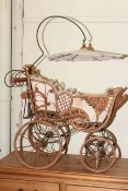 Victorian style wicker dolls pram with integrated parasol