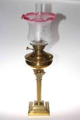 Brass corinthian column oil lamp with ruby tinted etched glass shade
