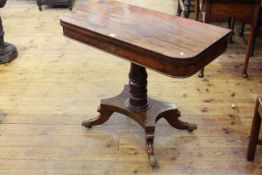 Regency mahogany fold top tea table raised on turned pedestal to four downswept legs