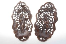 Pair shaped oval carved wood panels of Chinese figures,
