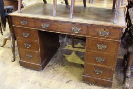 Late 19th Century oak nine drawer pedestal desk, 73cm by 118.