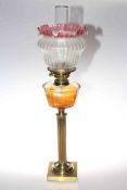Brass reeded column oil lamp with clear glass reservoir and ruby tinted etched shade