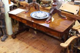 Early Victorian mahogany two drawer library table raised on pillar ends,