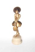 Art Deco gilded bronze figure of flapper with wide brim hat and feathers, on marble base,