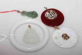 Three jade pendants together with a bangle and a red coloured pendant (5)