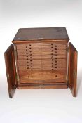 Mahogany coin collectors cabinet with eighteen drawers behind double doors fitted with brass