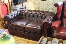 Chesterfield settee with ox blood leather and deep buttoned upholstery