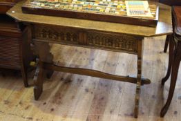 Oak two-drawer hall table, with trestle ends and arch-carved drawer fronts,