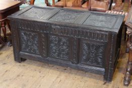 Carved oak coffer, with three panel lid and front,