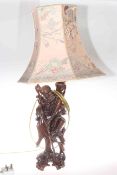 Carved Oriental figure lamp with silk shade