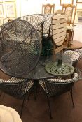 Circular green painted cast metal patio table, six chairs, smaller table and parasol stand,