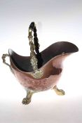 Late 19th Century copper coal helmet raised on three brass paw feet