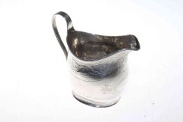 George III silver cream jug with bright cut band and cartouche,