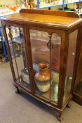 Walnut china cabinet on ball and claw feet, W.