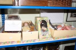 Seven various boxed dolls and a silvered dinosaur model